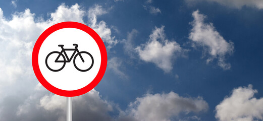 Red circle signboard, road sign on blue Sky. Stop halt allowed or do not enter. Bicycle or cyclist...