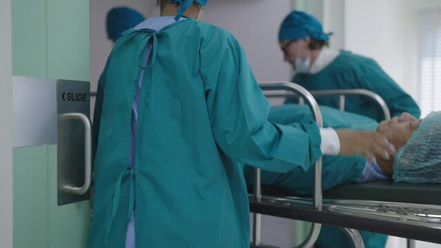 The medical team is rushing to bring the critically ill patient lying on the bed to request an emergency room for save the patient's life. Urgently pushing a patient bed to emergency room