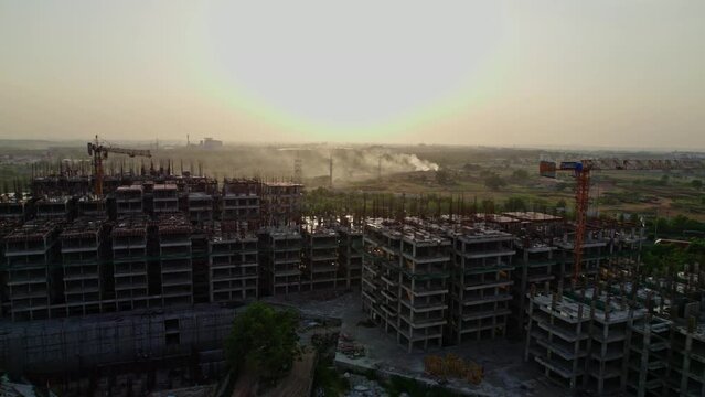 big construction building near express highway during sunset areal drone shot 4k 30p