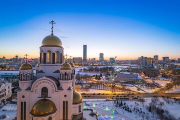 Obraz premium Winter Yekaterinburg and Temple on Blood in beautiful blue clear sunset. Aerial view of Yekaterinburg, Russia. Translation of the text on the temple: Honest to the Lord is the death of His saints.
