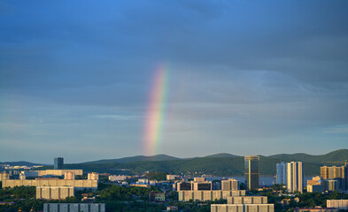 Vladivostok cityscape with rainbow, sunset view. Natural color of sky.