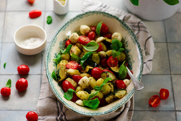 Italian Caprese salad with gnocchi and vegetables.. .style rustic