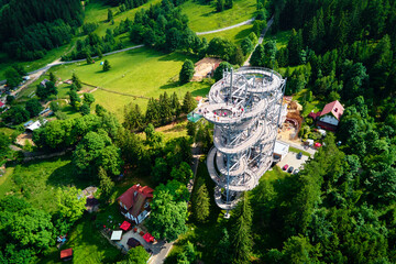 Sky Walk observation tower in Sweradow Zdroj, Poland. Tourist attraction in montains, aerial view. Panoramic view of nature landscape with green forest