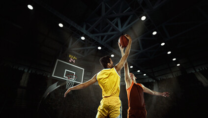 Fight for ball. Professional two basketball players in action with basketball ball at 3d model sports arena.