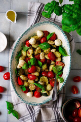 Italian Caprese salad with gnocchi and vegetables.. .style rustic