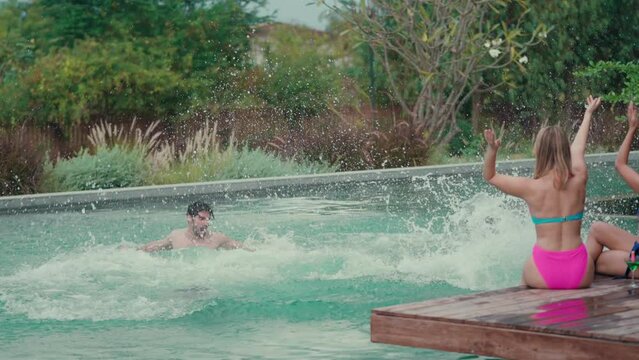 Groups of Multiculturalism Friends Jumping at poolside party and laughing fun at outdoors travel holiday vacation trip at private villa