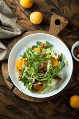 Healthy leaf salad with apricot and walnut