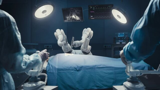 Two Surgeons Wearing Augmented Reality Headsets And Using High-Precision Remote Controlled Robot Arms To Operate On Patient In Futuristic Hospital. Doctors Working With Robotic Limbs, Observing Vitals