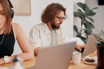 Couple of freelancers working together in modern coworking space. Distance work concept