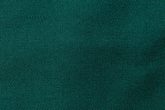 Dark desaturated cyan color fabric cloth polyester texture and textile background.