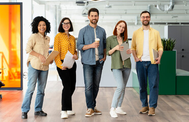 Corporate portrait multiracial business people, colleagues, coworkers looking at camera standing in modern office. Diversity. Group smiling student standing together in university campus, education