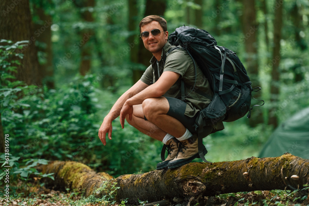 Wall mural tourist in summer forest. conception of exploration and leisure