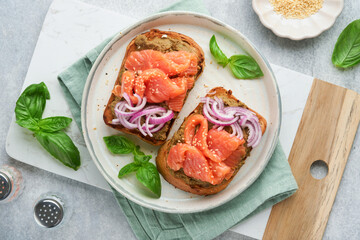 Sandwiches with salted salmon, avocado guacamole, red onions and basil. Smorrebrod. Set of danish open sandwiches. Healthy food, breakfast. Clean eating, dieting, vegan food concept. Top view.