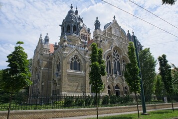 Fototapeta na wymiar Szeged, Hungary - Jun 15, 2023: A walking in the center of Szeged city in southwestern Hungary in a sunny spring day. Synagogue. Selective focus.