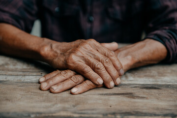 Male wrinkled hands, old man is wearing