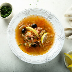 Traditional homemade soup with sausage and capers