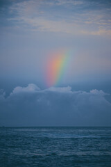 Rainbow Over the Sea Calm Water in the Evening after Raine