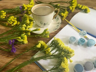 Cup of coffee and yellow flowers 