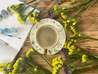 Cup of coffee and yellow flowers 