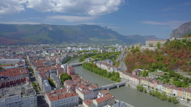 The drone aerial footage of the Isère River and Grenoble city, France. Grenoble is the prefecture and largest city of the Isère department in the Auvergne-Rhône-Alpes region of southeastern France.