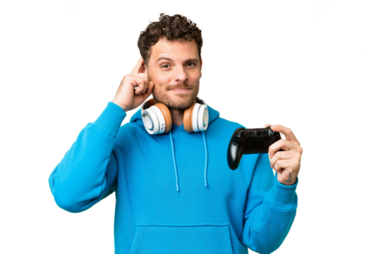 Brazilian man playing with a video game controller over isolated chroma key background having doubts