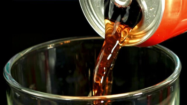 Cola is poured from a can into a glass. Filmed is slow motion 1000 fps. High quality FullHD footage