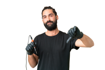 Tattoo artist caucasian man over isolated chroma key background showing thumb down with negative expression