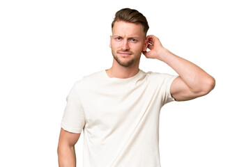 Young blonde caucasian man over isolated background having doubts