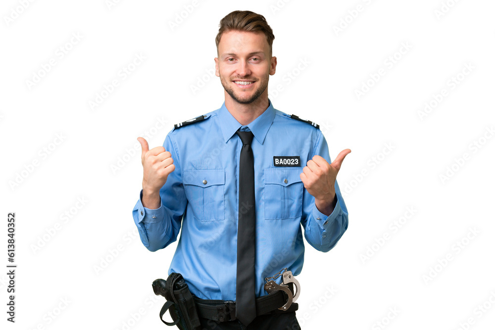 Wall mural Young police man over isolated background with thumbs up gesture and smiling