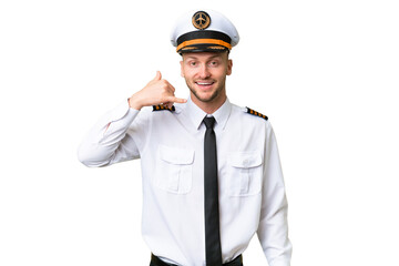 Airplane pilot man over isolated background making phone gesture. Call me back sign