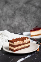 Tiramisu and cheesecake on dark background. delicious cakes