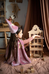 little girl dressed as a sorceress in a scandinavian children's room. © Маргарита Медведева