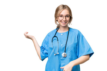 Young nurse English woman over isolated background making guitar gesture