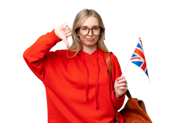 Young hispanic woman holding an United Kingdom flag over isolated background showing thumb down
