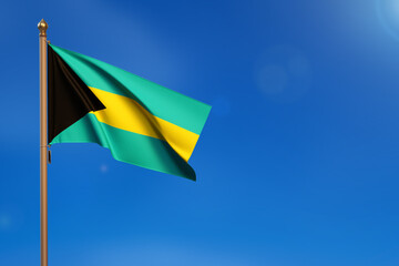 Bahamas. Flag blown by the wind with blue sky in the background