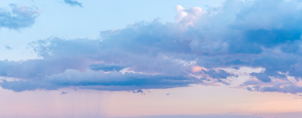 scenic blue seascape of sunset or sunrise above water with beautiful colorful evening clouds