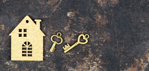 House shape and gold keys, buying, selling or renting home. Real estate banner with copy space.