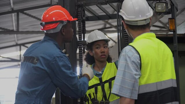 group of diversity Factory asian worker with Industrial Engineers inspector african american manager woman checking repair mechanical in Manufacturing Facility. teamwork meeting maintain forklift
