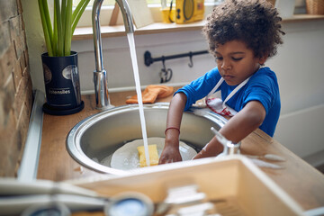 Squeaky Clean Adventures: Afro-American Boy's Sudsy Dishwashing Excitement