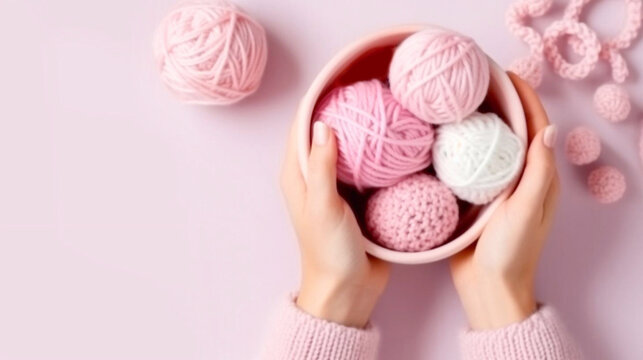 Female hands BEAUTIFUL close-up, knitting for a newborn, crochet.booties, top view on a soft pink blue beige background,tenderness,knitting needles,cotton,twig.AI generated