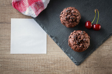 chocolate muffins with cherry and blank card.