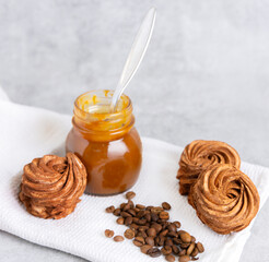 homemade marshmallow zephyr with coffee and caramel.natural ingredients.open book coffee cup.woman hand taking one piece.smiling face from coffee beans.dessert in box, or torn paper, diagonal lines