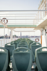 empty ferryboat seats in Venice Italy, in the background it can be seen the bell towers of Saint Marks Square and saint Giorgio Maggiore's Island