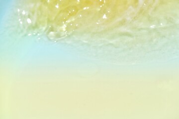 Blue water with ripples on the surface. Defocus blurred transparent blue colored clear calm water surface texture with splashes and bubbles. Water waves with shining pattern texture background.