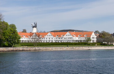 Fototapeta na wymiar Sonderborg beach in Denmark with windmill and beach hotel from the water
