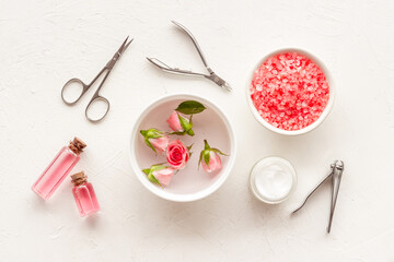 Manicure scissor and hands care cosmetics set with flowers.
