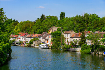 Fototapeta na wymiar Houses on the banks of the Loing river in Nemours, a small town in the south of the Seine et Marne department in Paris region, France