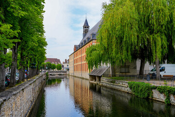 Canal of the river Loing passing by the Town Hall of Nemours in the south of the French department of Seine et Marne in Paris region