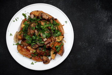 Fried potatoes with mushrooms, onions, herbs, homemade