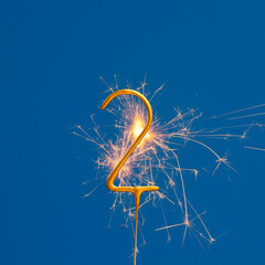 Birthday number 2 of sparks on blue background